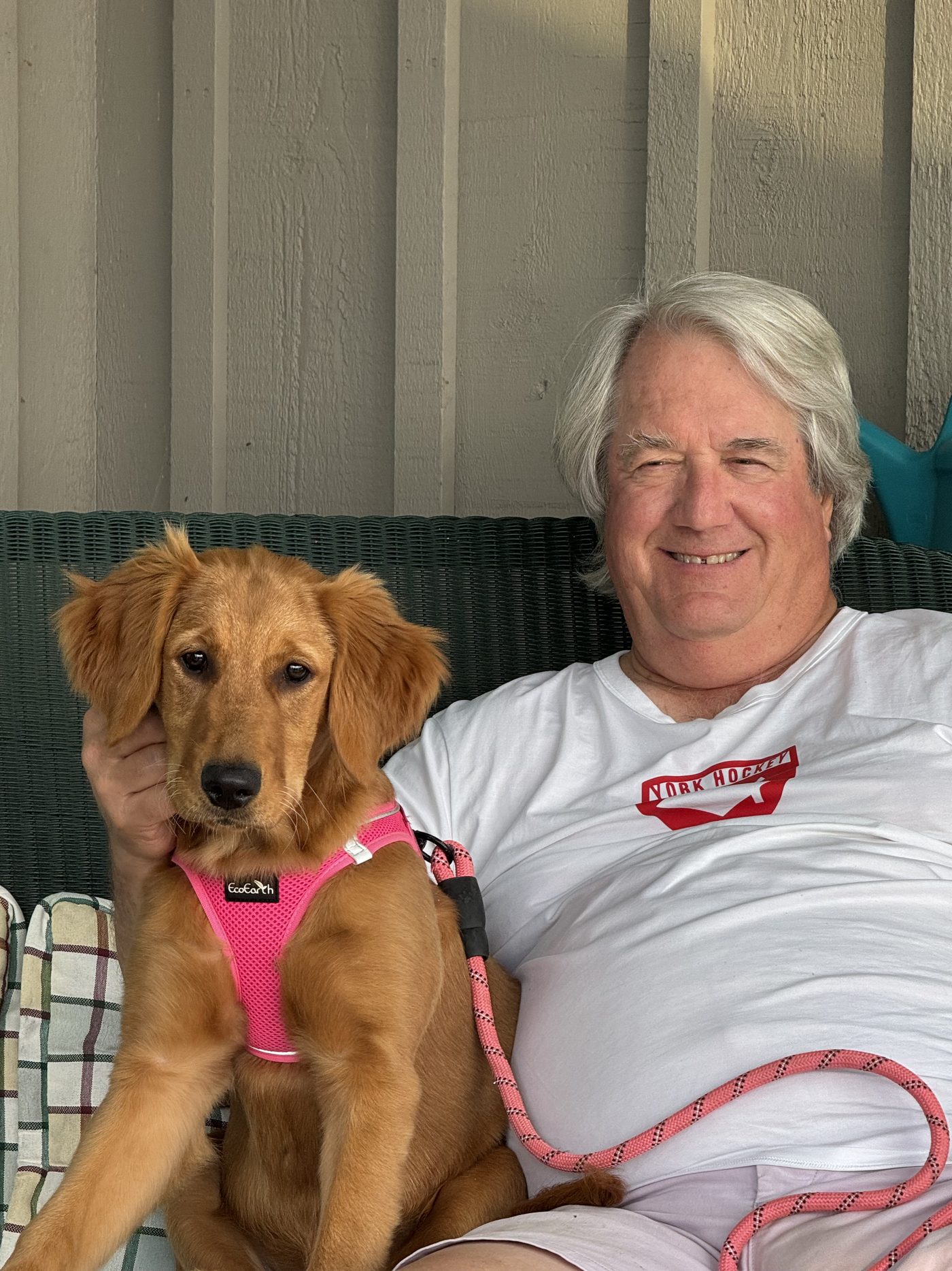Guy Burry on a porch with a golden retriever puppy